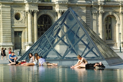 近日，一组中国游客在卢浮宫水池中泡脚的照片引众多网友指责。其实不少外国人也会在公共场所的喷泉水池里泡脚。图/东方IC